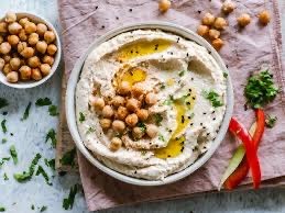 In Jordan, hummus is served with pita. The traditional breakfast spread includes hummus and pita, falafel, cheese, yogurt, and green olives.